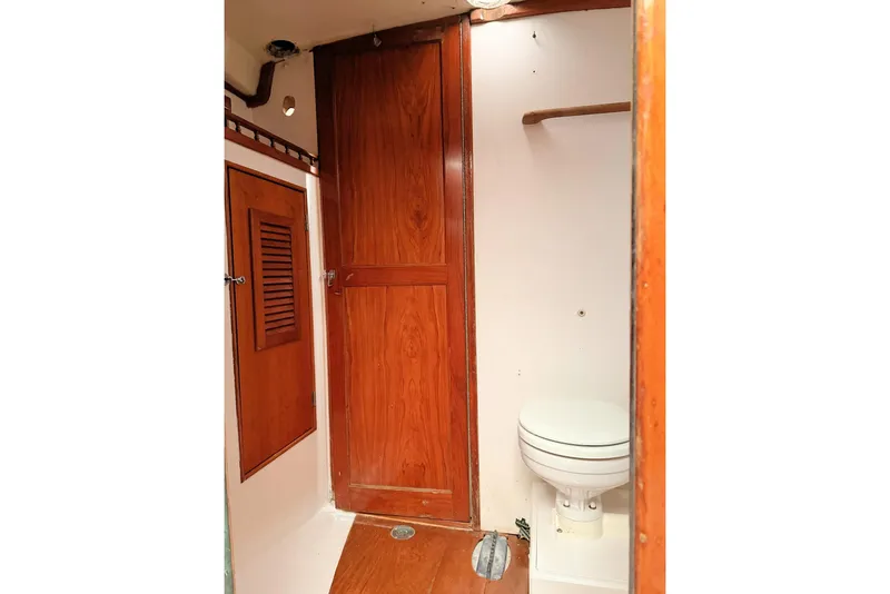 Slide: The Image of 1967 Columbia Constellation boat interior with wooden cabinetry and compact toilet. - 77