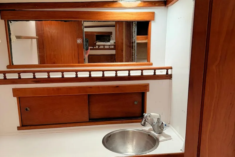 Slide: The Image of 1967 Columbia Constellation yacht bathroom with wooden cabinetry and stainless steel sink. - 79