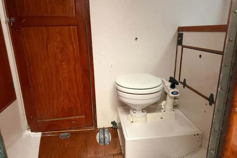Slide: The Image of 1967 Columbia Constellation boat bathroom with wooden door and marine toilet. - 80