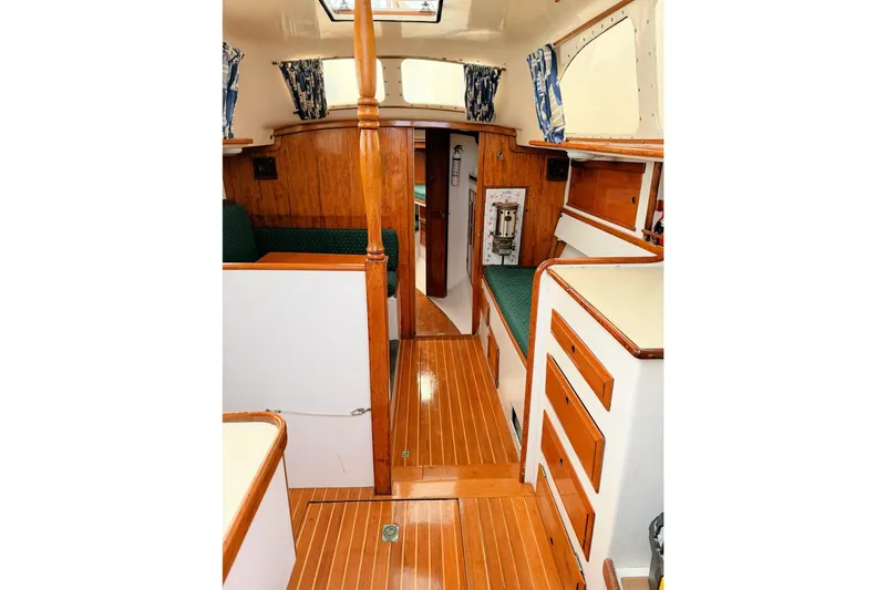 Slide: The Image of 1967 Columbia Constellation yacht interior with wood paneling and green seating. - 81