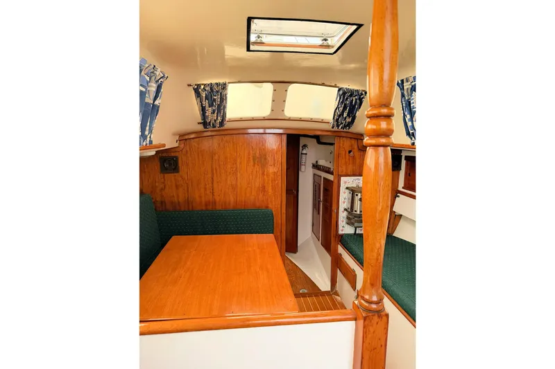 Slide: The Image of 1967 Columbia Constellation yacht interior with wood finish and green seating. - 82
