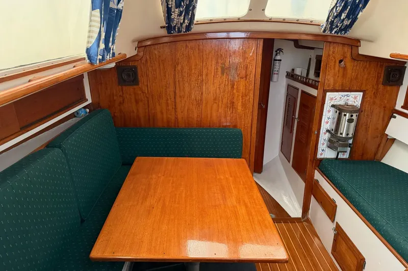 Slide: The Image of 1967 Columbia Constellation boat interior with wooden table, green seating, and nautical decor. - 83