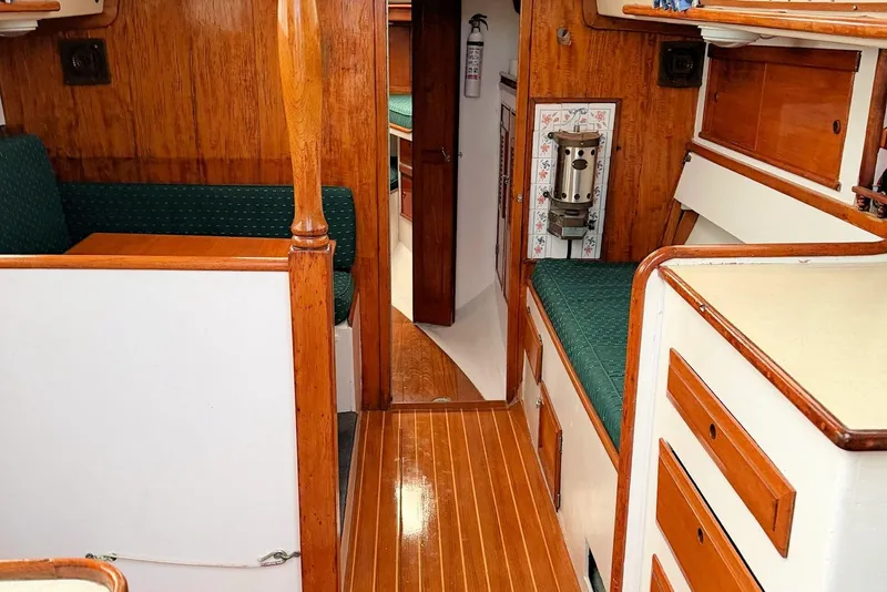 Slide: The Image of Interior of a 1967 Columbia Constellation sailboat with wood paneling and green seating. - 85