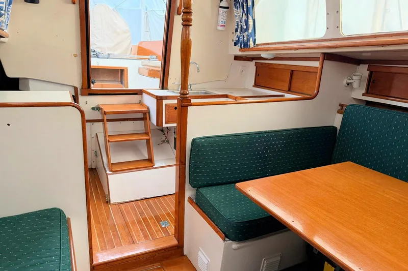 Slide: The Image of 1967 Columbia Constellation yacht interior with wooden finishes and green upholstered seating. - 89