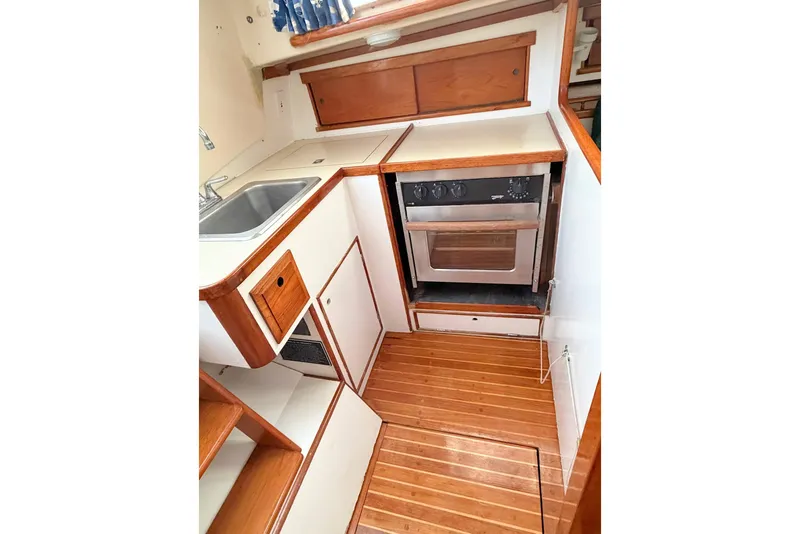 Slide: The Image of 1967 Columbia Constellation yacht kitchen with wood cabinetry and compact oven. - 93