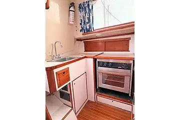 Slide: The Image of 1967 Columbia Constellation yacht kitchen with wood accents, sink, and oven. - 94