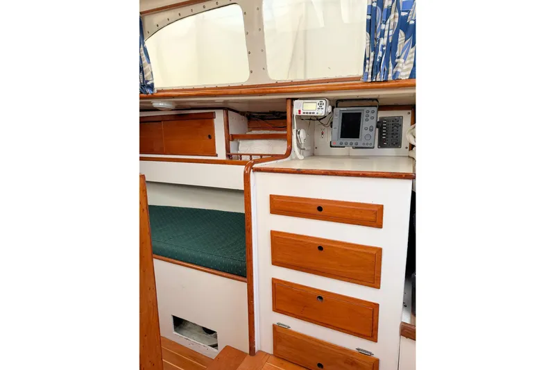 Slide: The Image of 1967 Columbia Constellation yacht interior with wooden drawers and navigation equipment. - 99