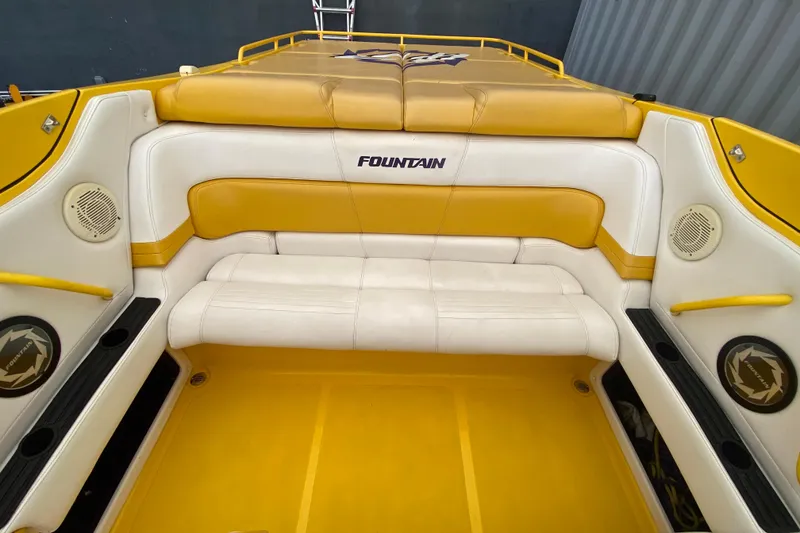 Slide: The Image of Interior of a 1999 Fountain 47 Lightning boat with yellow and white seating. - 19