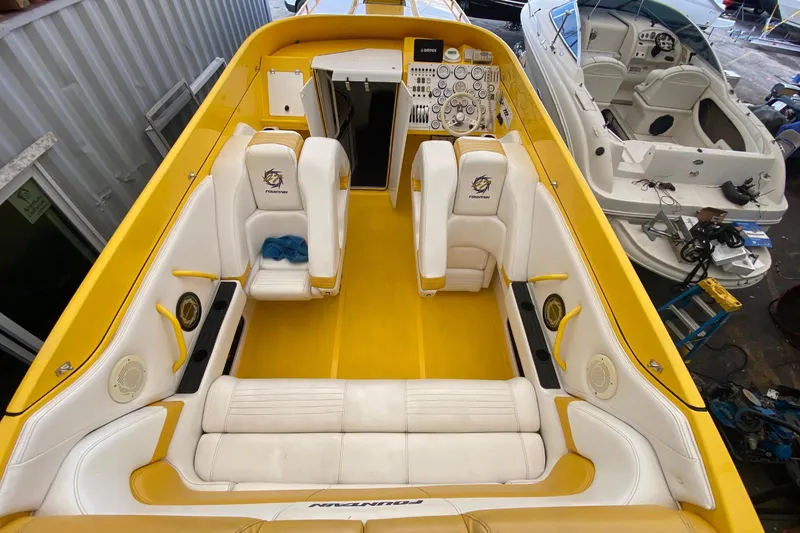 Slide: The Image of Interior of a 1999 Fountain 47 Lightning boat, yellow and white design. - 20