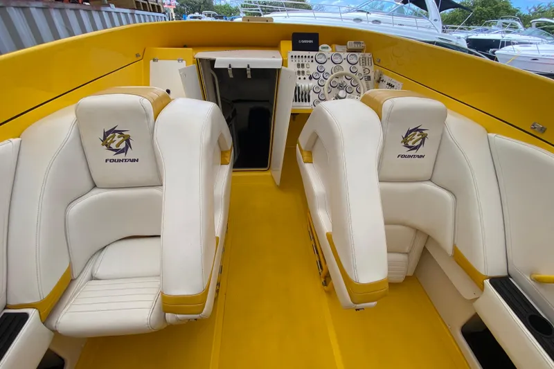Slide: The Image of Interior of a 1999 Fountain 47 Lightning boat with white and yellow seating. - 21