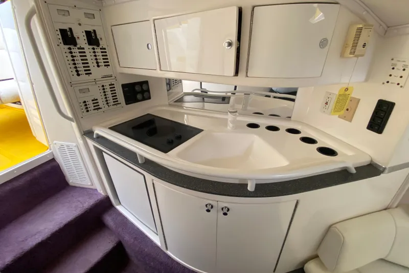 Slide: The Image of 1999 Fountain 47 Lightning boat interior with kitchenette and control panels. - 29