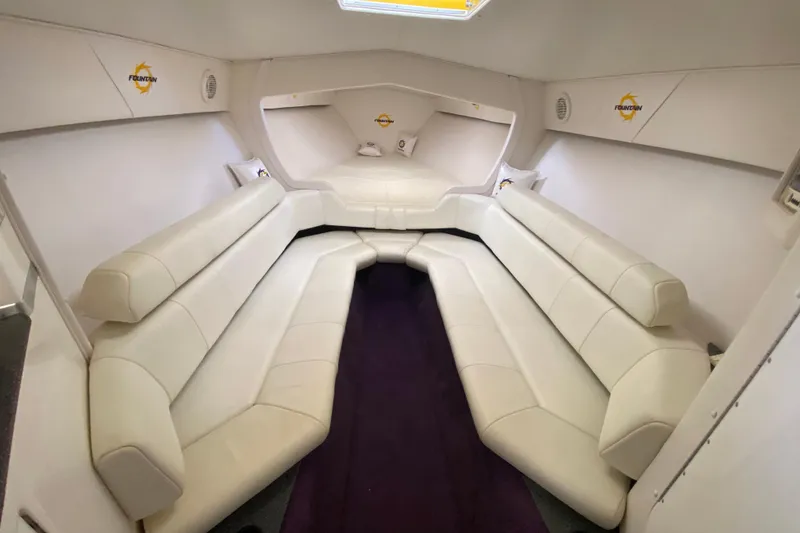 Slide: The Image of Interior of 1999 Fountain 47 Lightning boat with white leather seating and purple carpet. - 30