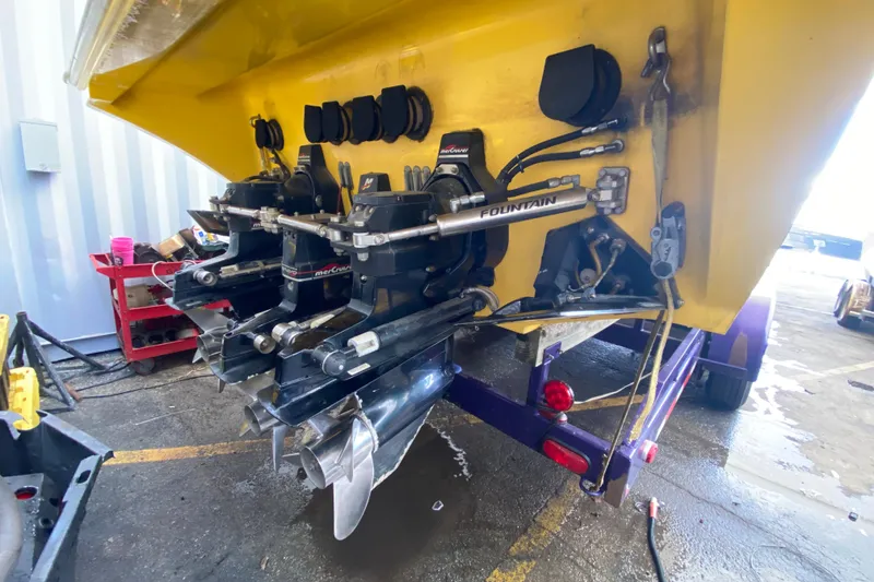 Slide: The Image of Rear view of a 1999 Fountain 47 Lightning boat with dual MerCruiser engines. - 43