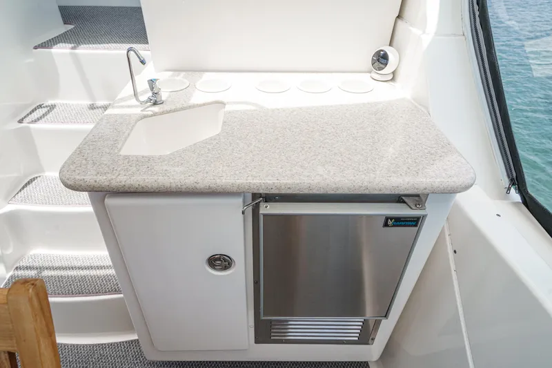 Slide: The Image of 2004 Silverton 39 Motor Yacht kitchenette with sink and mini fridge. - 12