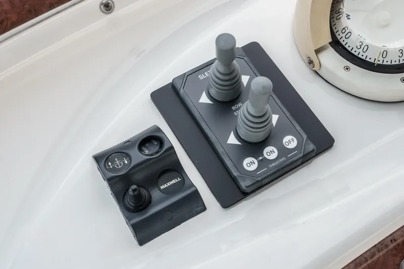 Slide: The Image of Control panel of a 2004 Silverton 39 Motor Yacht with joysticks and switches. - 20