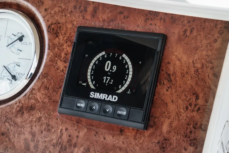 Slide: The Image of Simrad display on 2004 Silverton 39 Motor Yacht dashboard, featuring navigation controls. - 22