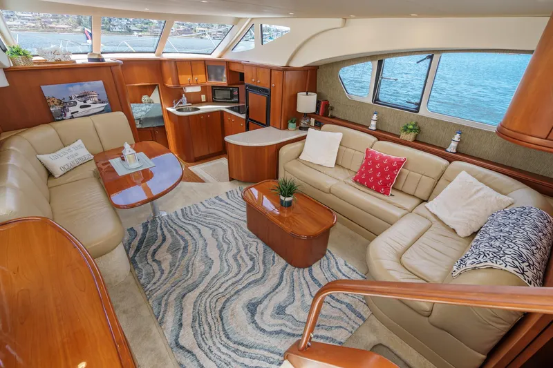 Slide: The Image of Luxurious interior of 2004 Silverton 39 Motor Yacht with elegant seating and scenic windows. - 23