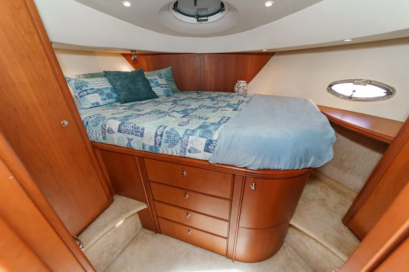 Slide: The Image of Luxurious bedroom in 2004 Silverton 39 Motor Yacht with cozy bedding and elegant wood cabinetry. - 30