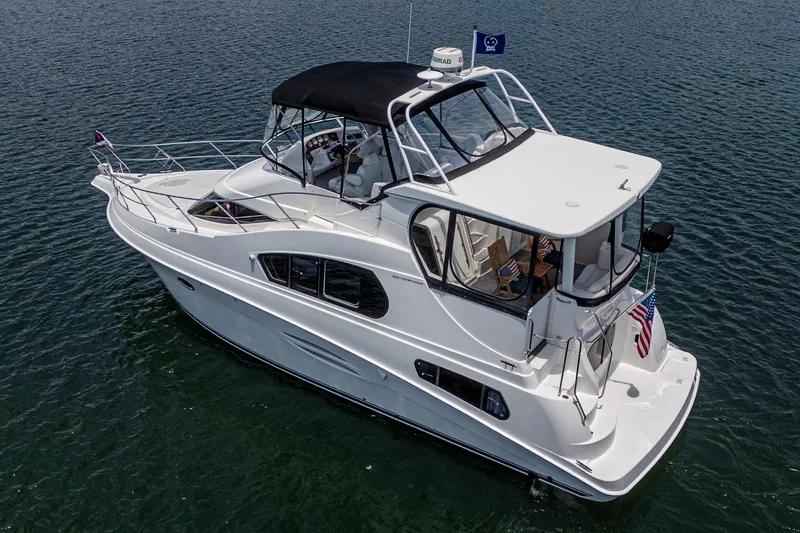 Slide: The Image of 2004 Silverton 39 Motor Yacht cruising on calm waters. - 4