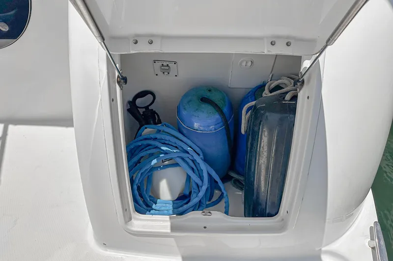 Slide: The Image of Storage compartment on a 2004 Silverton 39 Motor Yacht with blue ropes and fenders. - 5