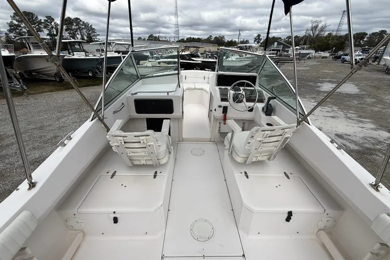 Slide: The Image of 2000 Grady-White Freedom 225 boat interior with seating and steering wheel. - 10