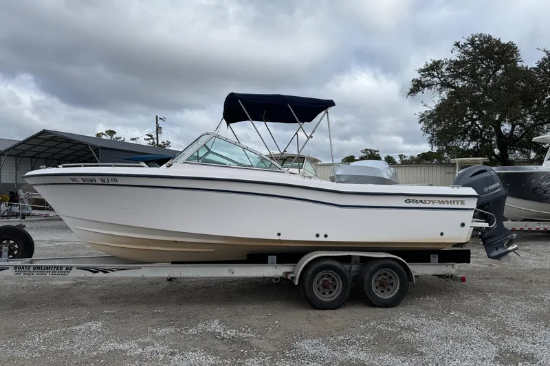 Slide: The Image of 2000 Grady-White Freedom 225 boat on trailer, outdoor setting, overcast sky. - 4
