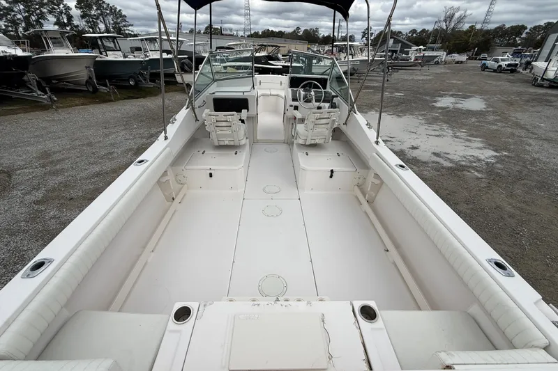 Slide: The Image of 2000 Grady-White Freedom 225 boat interior with seating and steering wheel, parked outdoors. - 8