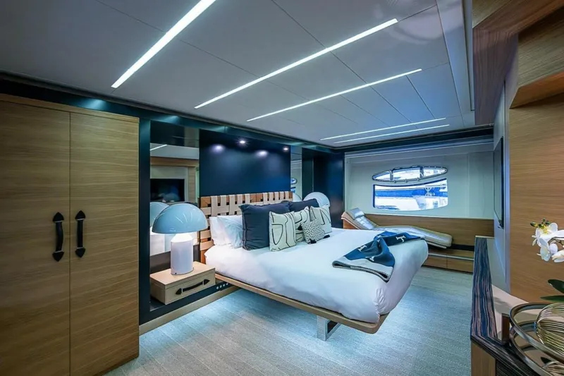 Slide: The Image of Luxurious bedroom interior on a 2014 Pershing 92 yacht, featuring modern design and elegant furnishings. - 12