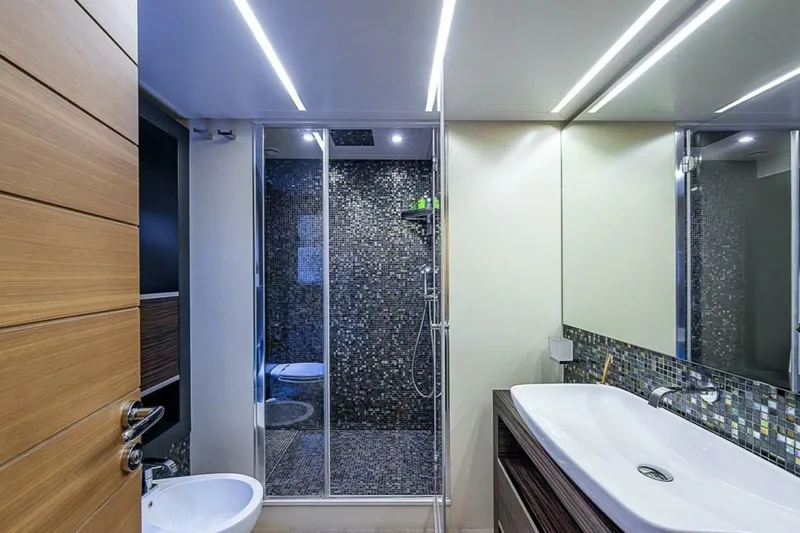 Slide: The Image of Luxurious bathroom on 2014 Pershing 92 yacht with modern fixtures and mosaic tiles. - 17