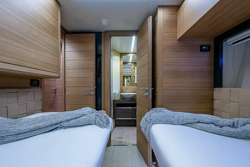 Slide: The Image of Luxurious interior of 2014 Pershing 92 yacht with twin beds and modern wood finish. - 22