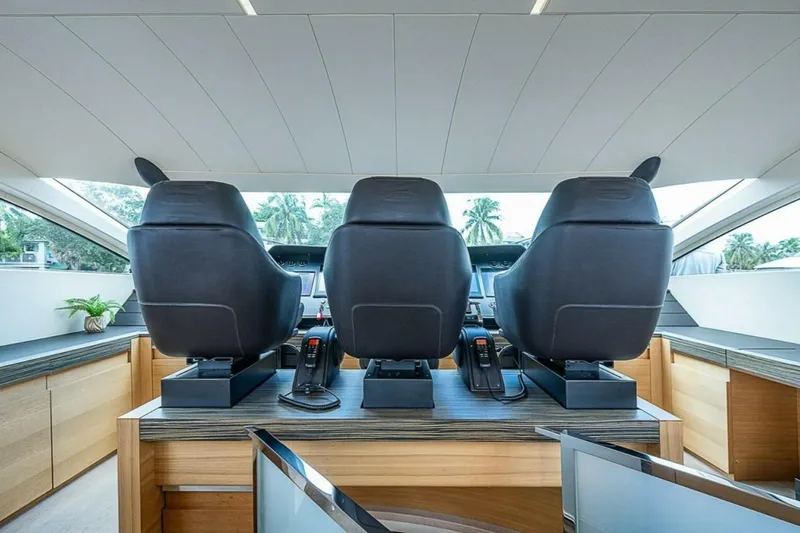Slide: The Image of Interior helm of 2014 Pershing 92 yacht with three black captain chairs. - 25