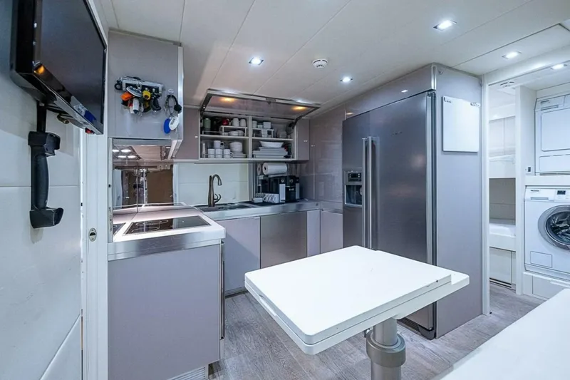 Slide: The Image of Modern kitchen interior on 2014 Pershing 92 yacht, featuring sleek appliances and ample storage. - 28