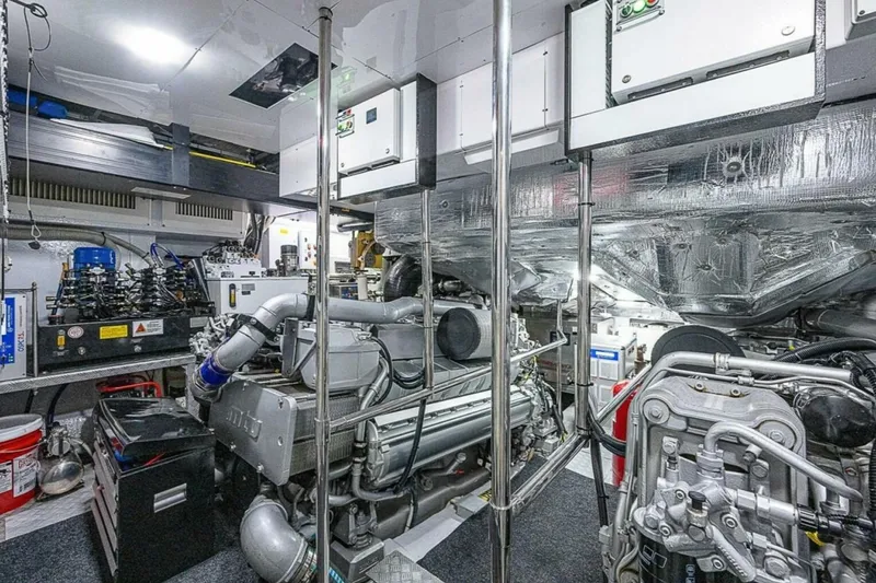 Slide: The Image of Engine room of a 2014 Pershing 92 yacht, showcasing advanced machinery and equipment. - 30