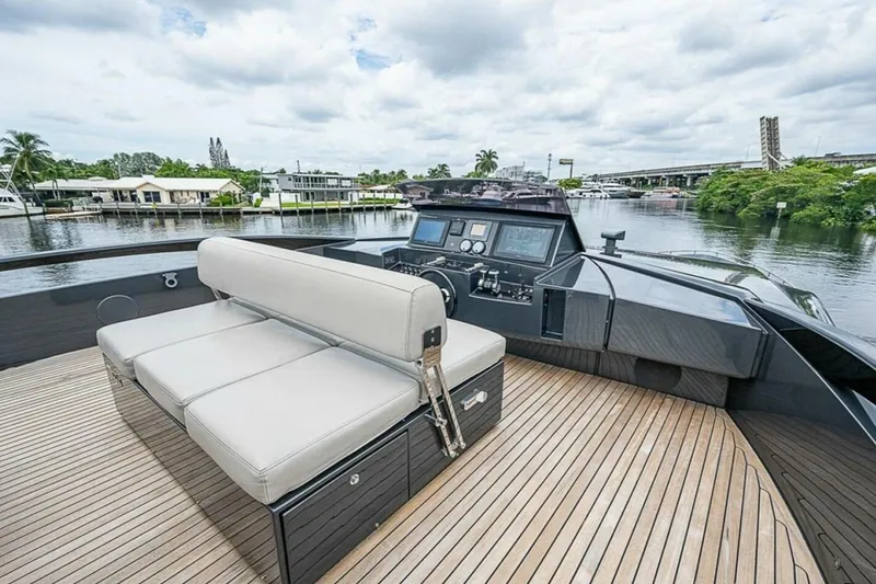 Slide: The Image of Luxurious 2014 Pershing 92 yacht with sleek deck and modern seating, docked by a scenic waterfront. - 33