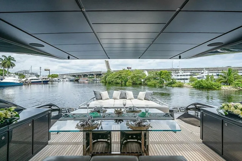 Slide: The Image of Luxurious 2014 Pershing 92 yacht deck with elegant seating and scenic waterfront view. - 4