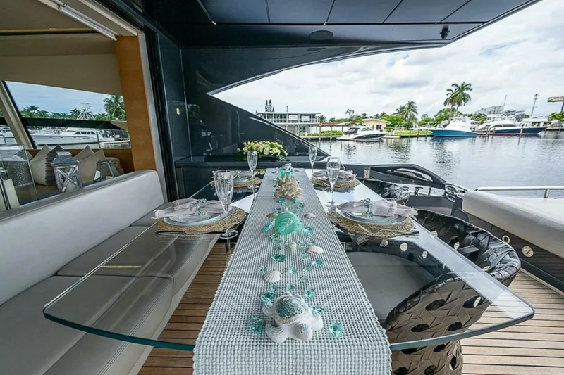 Slide: The Image of Luxurious dining setup on 2014 Pershing 92 yacht with waterfront view. - 5