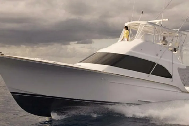 Slide: The Image of 2027 Buddy Davis 52 Sportfisherman cruising on open water under cloudy skies. - 3