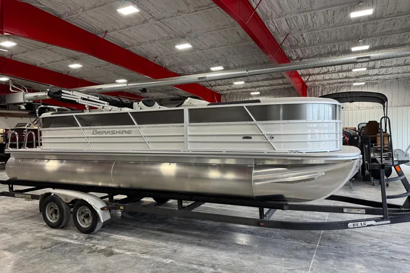 The Image of 2026 Berkshire 24RFX LE pontoon boat on trailer in indoor showroom. - 1