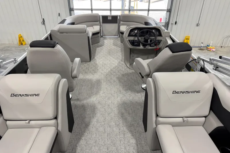 Slide: The Image of 2026 Berkshire 24RFX LE pontoon boat interior with plush seating and modern helm. - 13