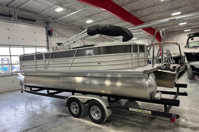 Slide: The Image of 2026 Berkshire 24RFX LE pontoon boat on trailer in indoor storage facility. - 3