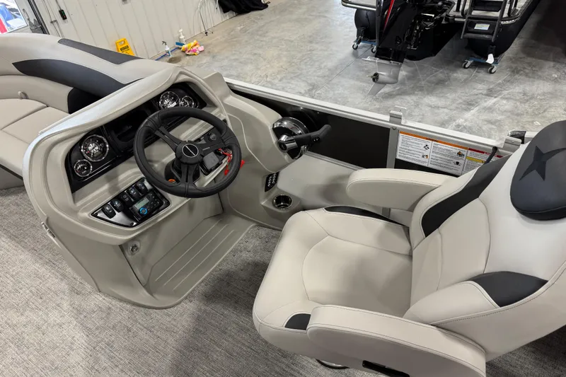 Slide: The Image of 2026 Berkshire 24RFX LE boat interior with steering wheel and captain's chair. - 8