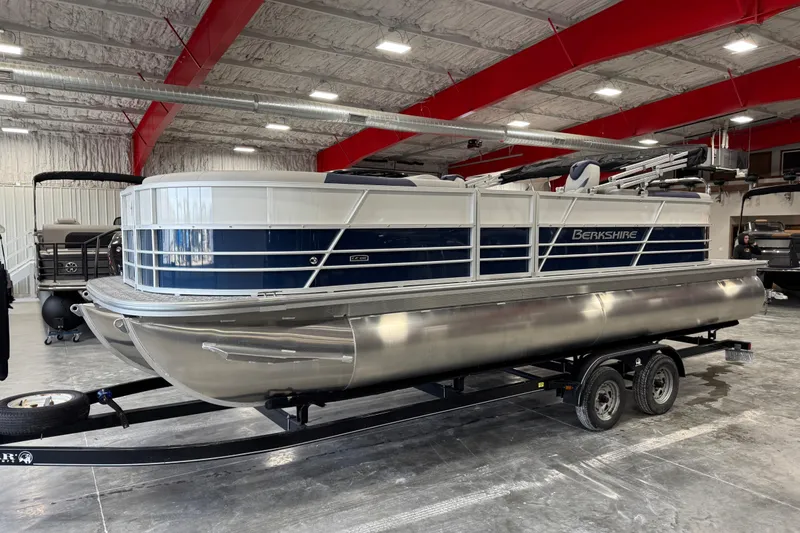 The Image of 2026 Berkshire 24RFX LE pontoon boat in a showroom on a trailer. - 1