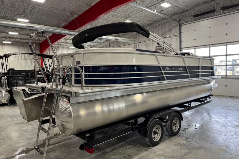 Slide: The Image of 2026 Berkshire 24RFX LE pontoon boat on trailer in indoor showroom. - 3