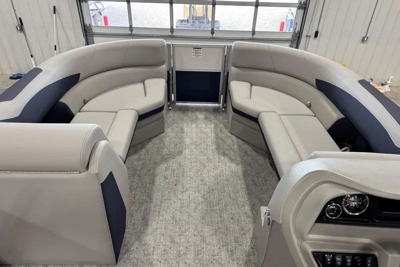 Slide: The Image of Interior of 2026 Berkshire 24RFX LE pontoon boat with plush seating and modern dashboard. - 9