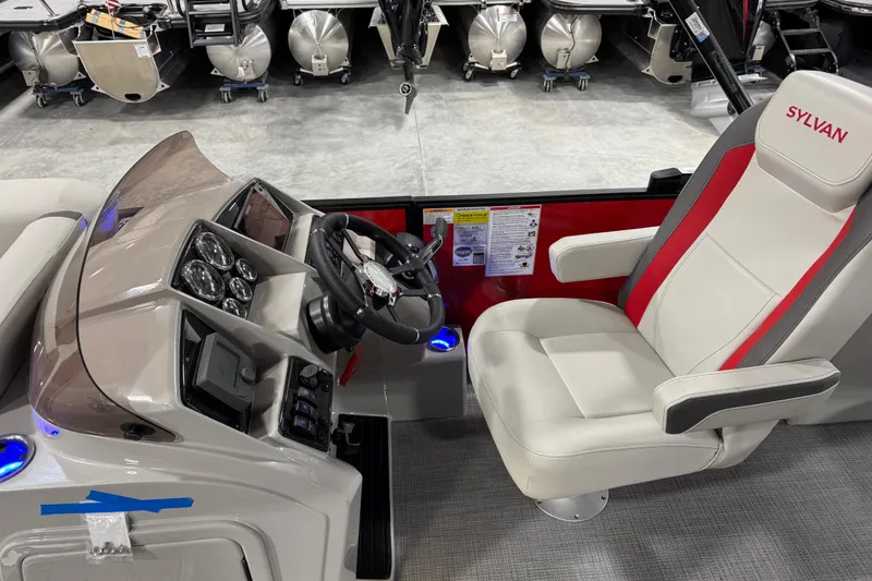 Slide: The Image of 2026 Sylvan X-5 boat interior with steering console and captain's chair. - 14