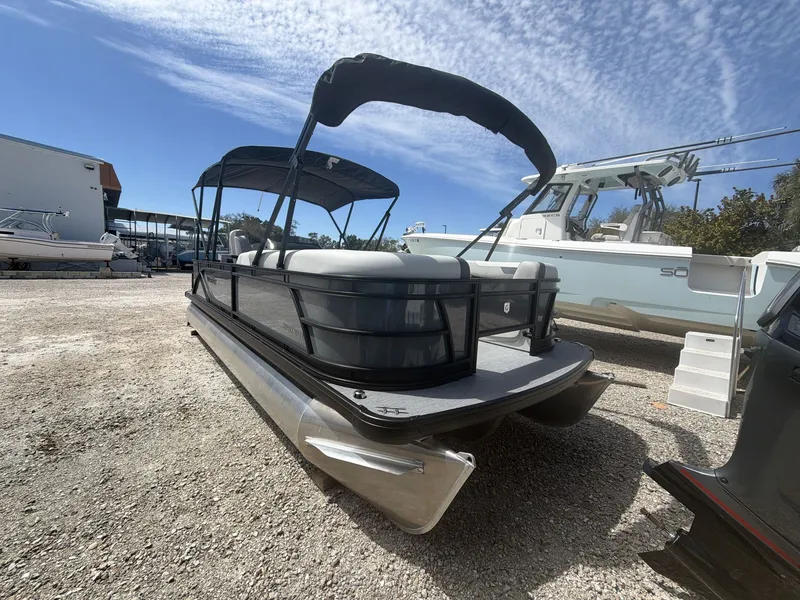 Slide: The Image of 2026 Sweetwater 2286 FS pontoon boat on gravel lot. - 3