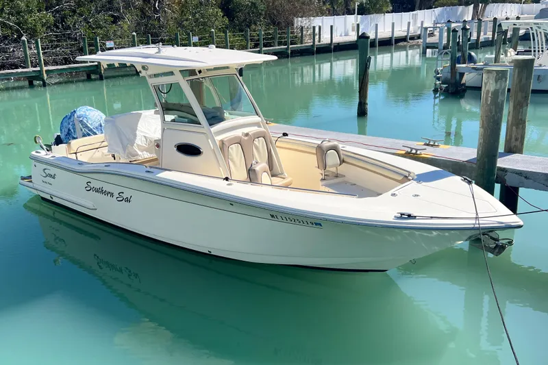 The Image of 2015 Scout 255 LXF boat docked in clear turquoise water. - 1
