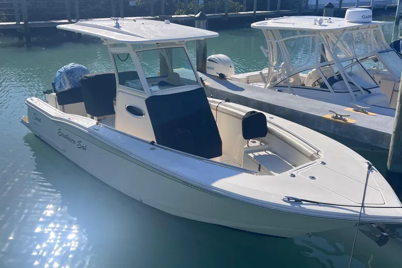 Slide: The Image of 2015 Scout 255 LXF boat docked in sunny marina. - 14