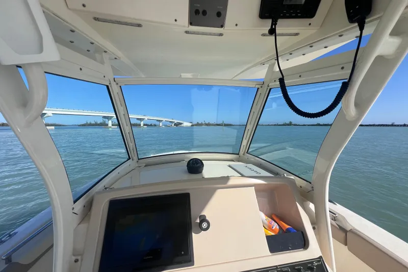 Slide: The Image of Interior view of 2015 Scout 255 LXF boat with bridge in background. - 25