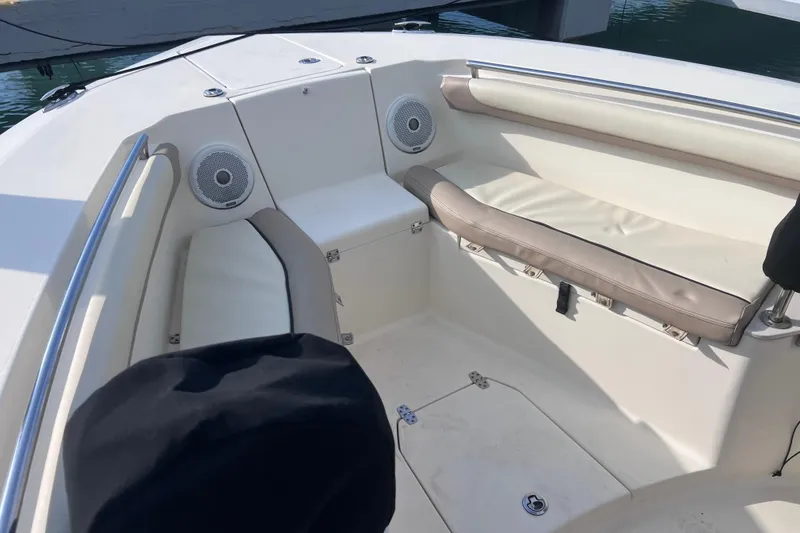 Slide: The Image of 2015 Scout 255 LXF boat interior with cushioned seating and speakers. - 31